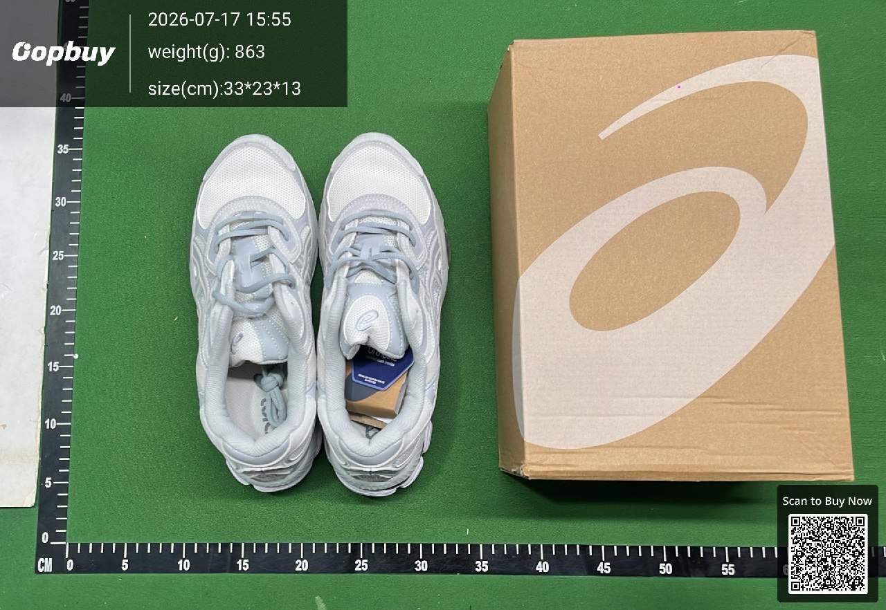 Two trainers and their box on a green warehouse mat